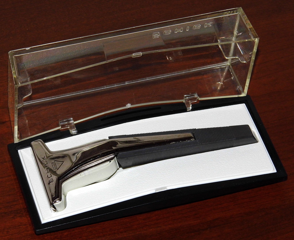 A classic razor with replacement blade cartridges, illustrating the ongoing cost of shaving your head with a razor