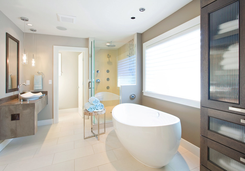 A modern bathroom vanity with a wall-mounted mirror, a good spot to shave your head