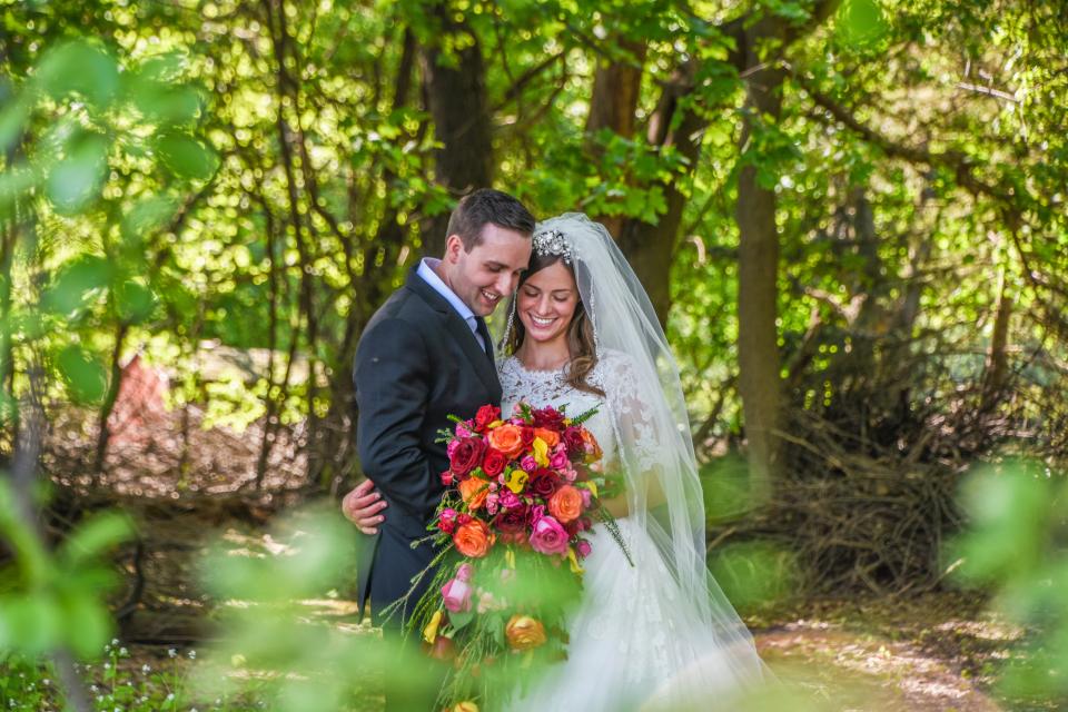 A clean-shaven, well-groomed man with his partner at their wedding, a classic big event to shave your head for