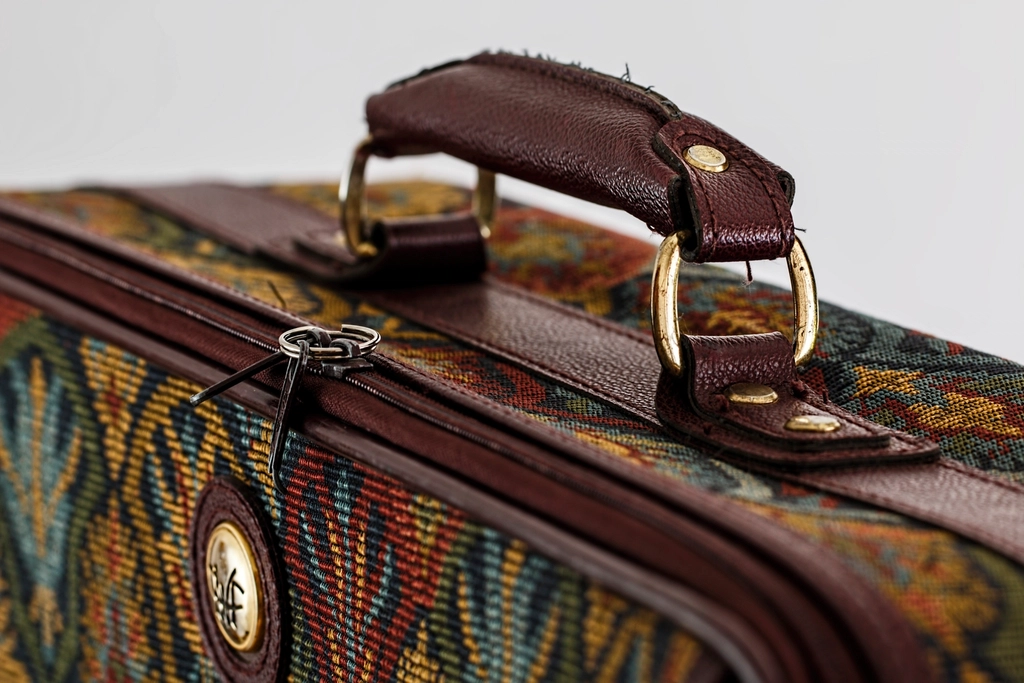 A packed suitcase ready for travel with a head shaver inside