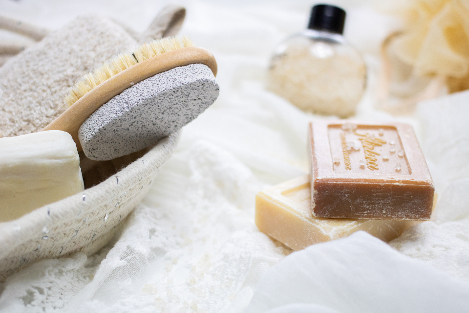 A basket of bath soap, a pumice stone and a body brush — the kind of gentle cleansers a shaved scalp actually needs
